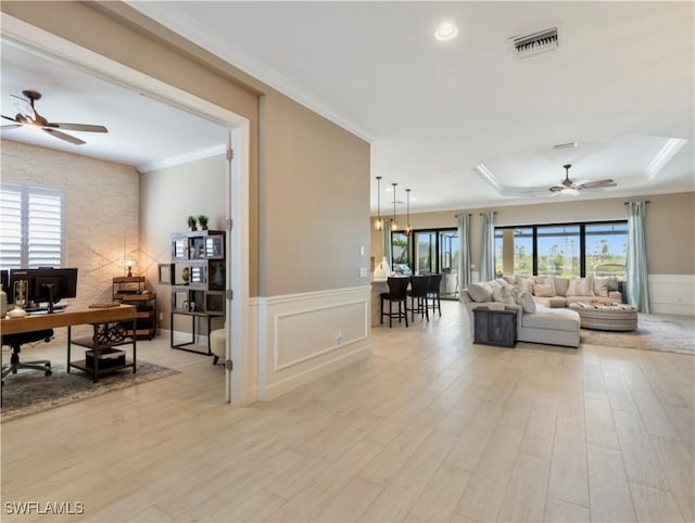 living room with ceiling fan, light hardwood / wood-style floors, and ornamental molding