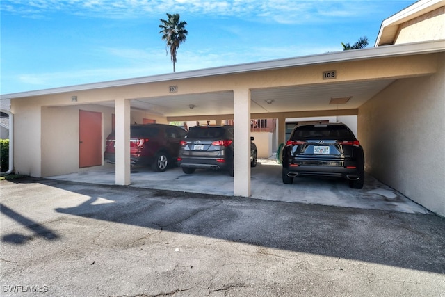 view of parking / parking lot featuring a carport