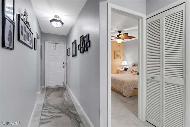 hall with light tile patterned floors