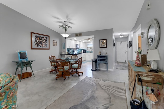 dining space with vaulted ceiling