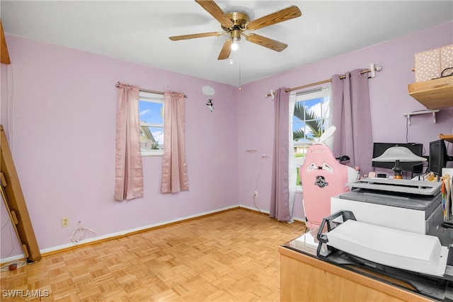 home office with ceiling fan and light parquet floors