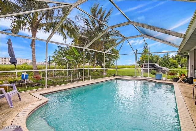 view of pool with a patio area and a lanai