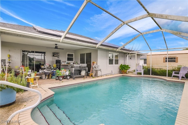 view of pool featuring glass enclosure and a patio area