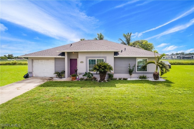 ranch-style house featuring a garage and a front lawn