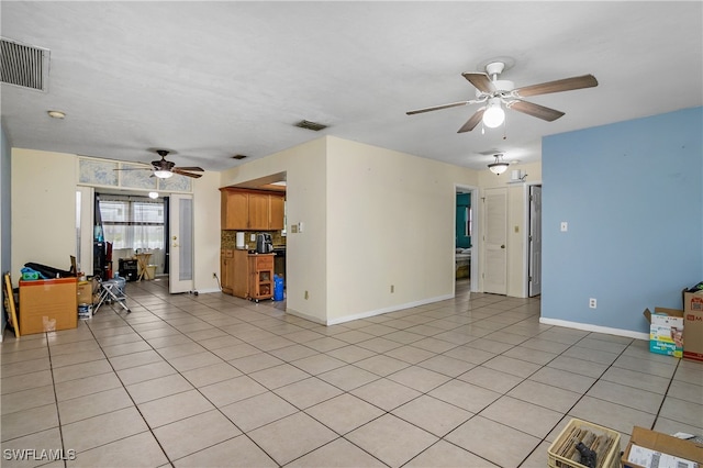 unfurnished living room with light tile patterned floors and ceiling fan