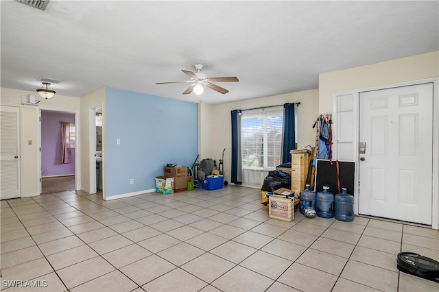 tiled entryway featuring ceiling fan