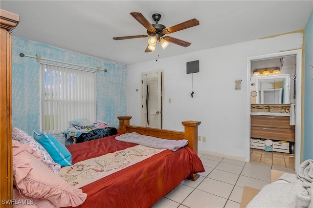 tiled bedroom featuring connected bathroom and ceiling fan