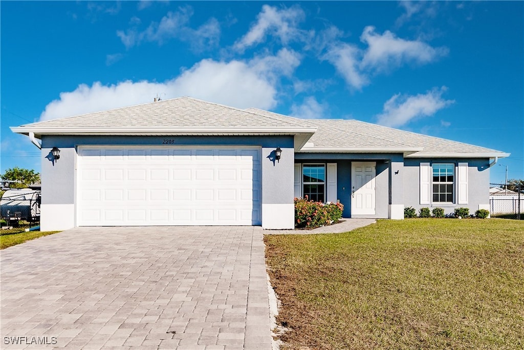 single story home with a front lawn and a garage