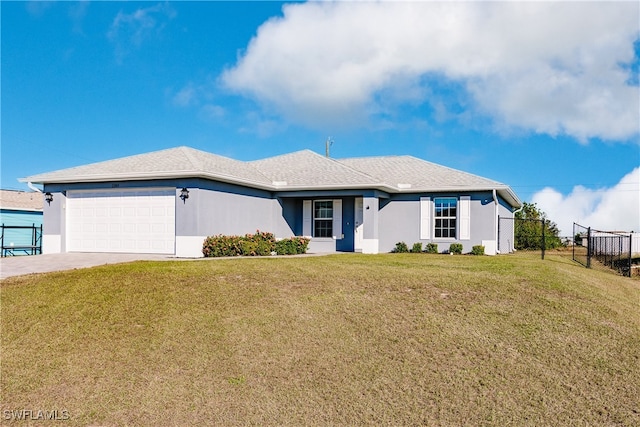 ranch-style house featuring a front yard and a garage