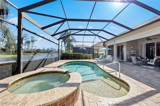 view of swimming pool featuring a water view, glass enclosure, an in ground hot tub, ceiling fan, and a patio