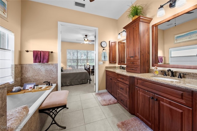 bathroom featuring vanity, tile patterned floors, a bathing tub, and ceiling fan