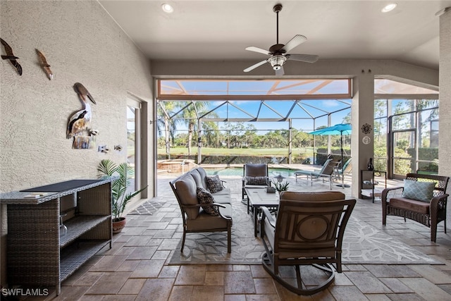 sunroom / solarium featuring ceiling fan