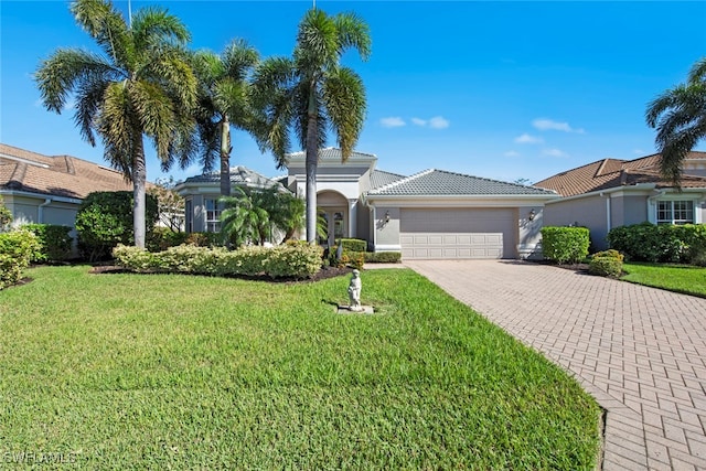 view of front of home featuring a garage and a front yard