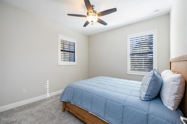 bedroom with ceiling fan and light carpet