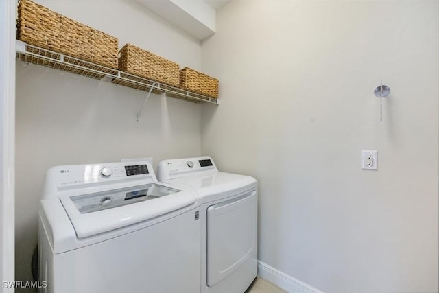 clothes washing area featuring independent washer and dryer