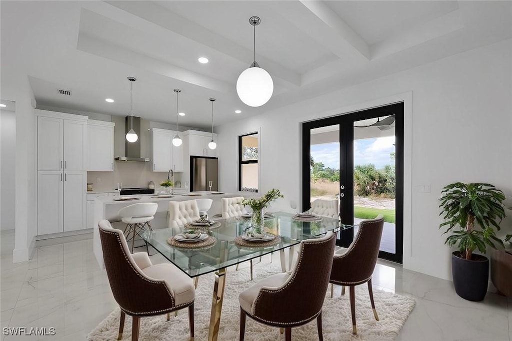 dining area featuring beamed ceiling and french doors