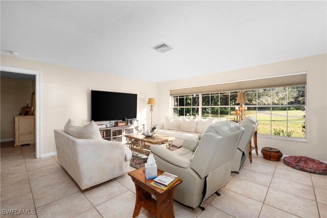 living room featuring plenty of natural light and light tile patterned floors