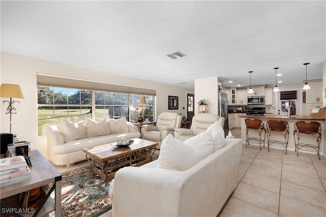 living room featuring light tile patterned floors and sink