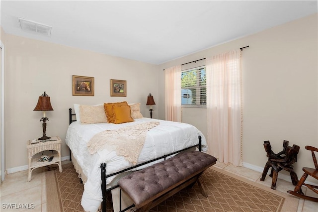 bedroom with light tile patterned floors