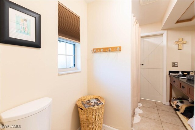 bathroom featuring tile patterned flooring and toilet