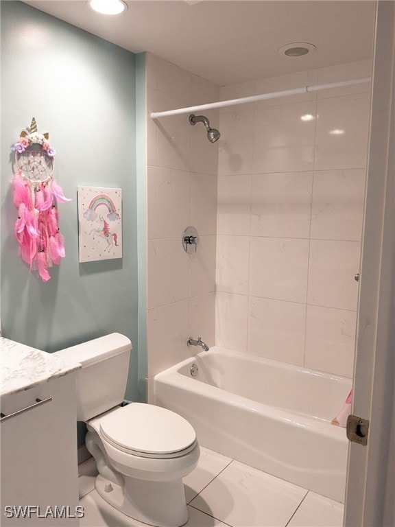 full bathroom with tile patterned flooring, vanity, tiled shower / bath combo, and toilet