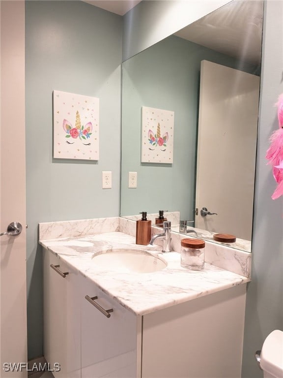 bathroom featuring vanity and toilet