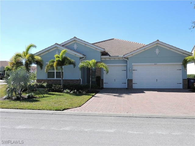 view of front facade with a front yard and a garage