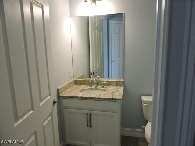 bathroom with vanity and toilet