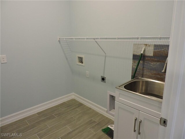 laundry area with cabinets, washer hookup, hookup for an electric dryer, and sink