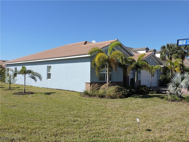 view of home's exterior with a lawn and a garage