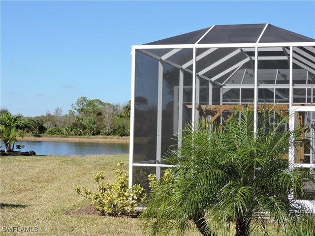 exterior space featuring glass enclosure and a water view