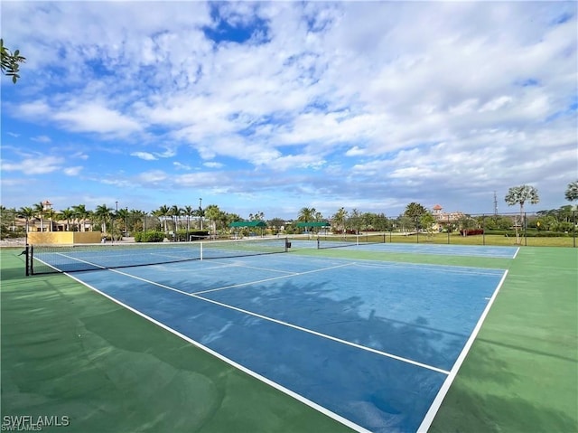 view of tennis court featuring basketball hoop