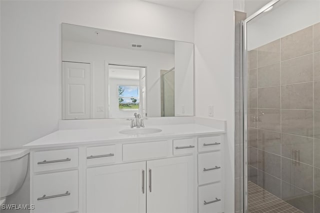 bathroom featuring vanity, toilet, and an enclosed shower