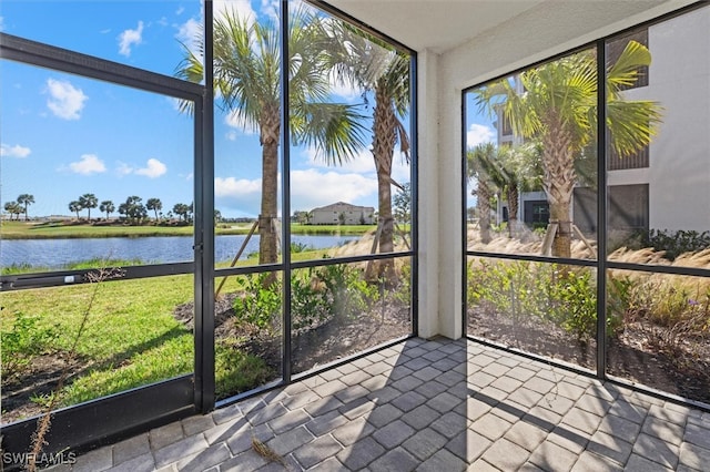 sunroom with a water view and a healthy amount of sunlight