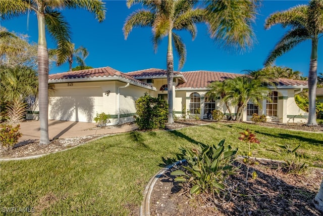 mediterranean / spanish-style house with a front lawn and a garage