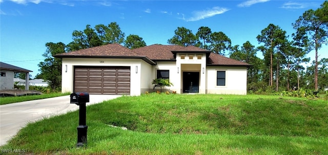 view of front of home featuring a garage and a front lawn