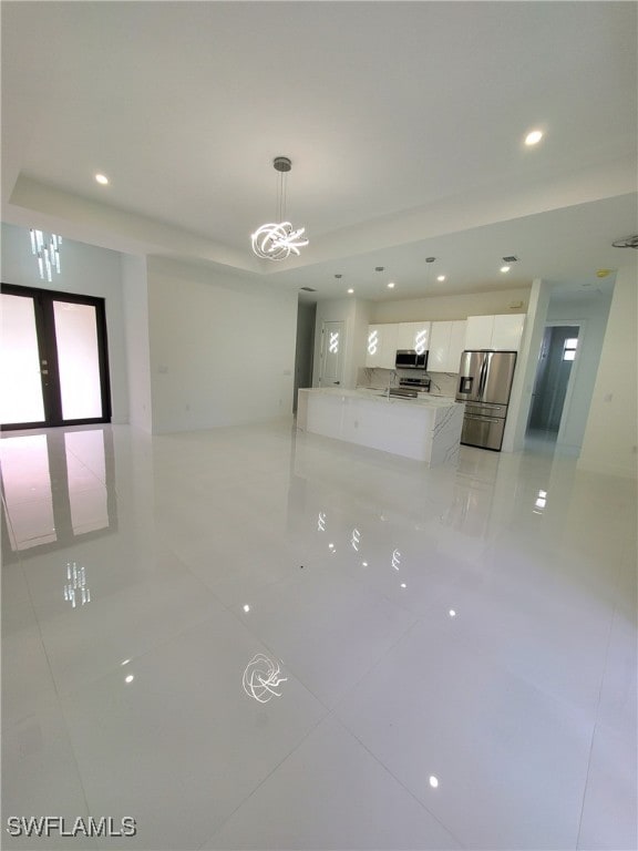 spare room featuring light tile patterned floors and french doors