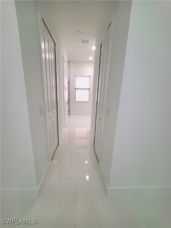 hallway with light tile patterned floors