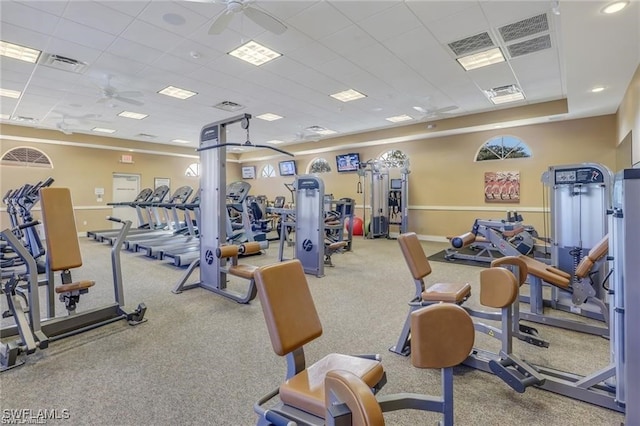 workout area with a paneled ceiling, visible vents, baseboards, and ceiling fan