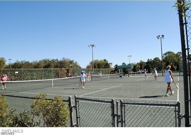 view of tennis court with fence