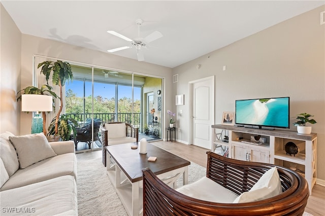 living room featuring light wood-type flooring and ceiling fan