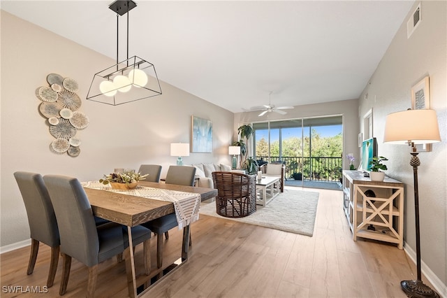 dining room with light hardwood / wood-style flooring and ceiling fan