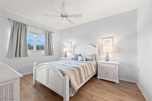 bedroom featuring baseboards, ceiling fan, and light wood-type flooring