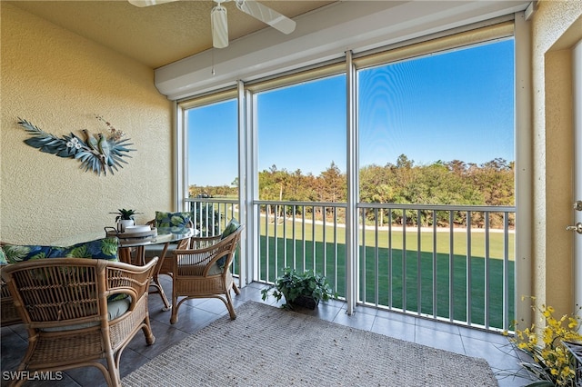 sunroom featuring ceiling fan