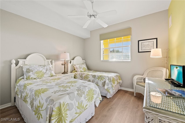 bedroom with baseboards, wood finished floors, and a ceiling fan