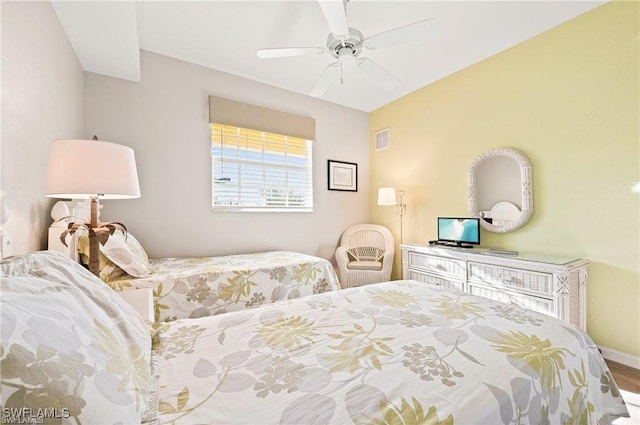 bedroom with baseboards, ceiling fan, and visible vents