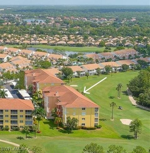 drone / aerial view with golf course view and a residential view