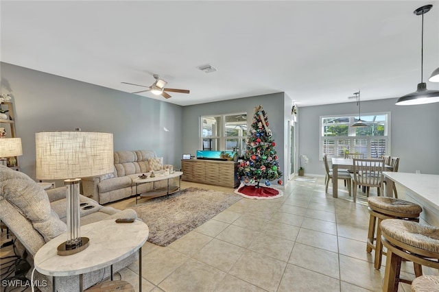 living room with ceiling fan and light tile patterned flooring