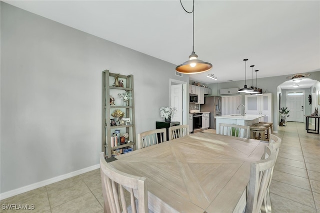 dining room with light tile patterned flooring and sink