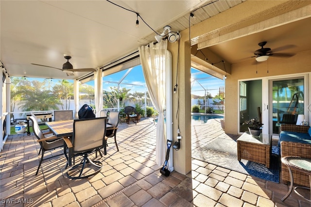 view of patio / terrace with ceiling fan and a lanai